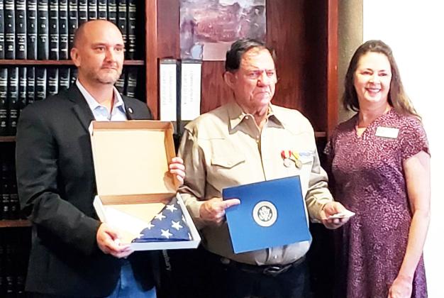 IT'S ABOUT TIME- Menard County Judge Brandon Corbin, left, presented James Ray Baker with his military honors earned in Vietnam. Because of a paperwork error, Baker had been listed as dishonorably discharged from the U.S. Army. The incorrect status was finally righted thanks to Congressman Pfluger's office and the local veterans coalition. Baker is pictured center. Carol Cunningham, right, was present from Pfluger's camp. Menard County photo.