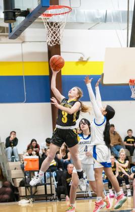 BELOW- Marlee Salas lays it up in the Jackets' 90-18 district win over Olfen on January 30. Julius Zamora (#10) and Eli Weatherly (#2) pictured foreground. RIGHT- Isabelle Devine goes for 2 in the Menard girls' 64-18 victory over Olfen on Jan. 30. The Lady Jacket win over Eden this week has secured their district title. Photos by Nora Davis. Additional basketball photos on page 8.