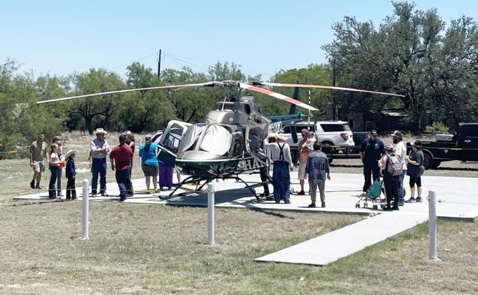 ABOVE- Visitors to the annual Ft. McKavett Volunteer Fire Department fundraiser look over the Shannon AirMed1 helicopter which was on hand for the dedication of the new helipad at the fire station on Saturday, June 11.