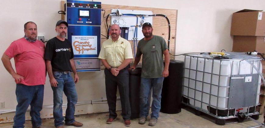 Menard County Emergency Coordinator Jeff Whitson, installer Jessy Haney, High School Principal Jacob Hand, and MISD maintenance supervisor Beau Tipton with the new anolyte generaor provide by Concho County Hospital. TMN photo.