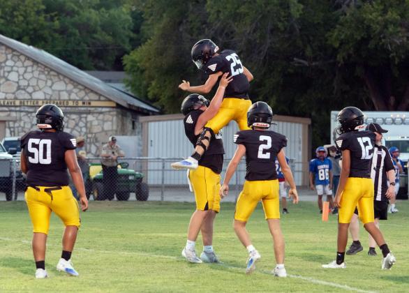 Varsity Jackets celebrate a good play during last week's scrimmage against Gorman. Pictured left to right: Zeke Hernandez, Tate Wagner, Colby Powell, Logan Powell, Jayden Payton. Menard travels to Blanket Friday night. JV will host Blanket here at home on Thursday at 6:00. Nora Davis photo.