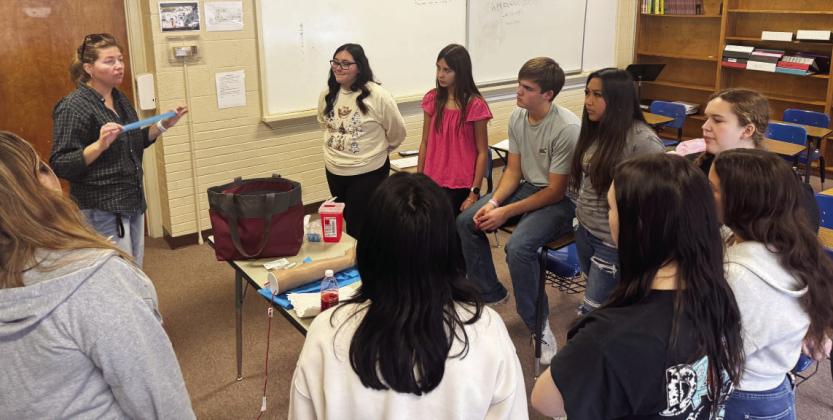 Menard High School Health Club members participated in a phlebotomy lesson courtesy Frontera Healthcare and the Texas A&amp;M Rural Health Initiative. Pictured face-forward, left to right: Lauren Morgan, instructor; students Aliah Saiz, Danni Ruiz, Cado Bannowsky, Nadia Garcia, Kasey McCollom. Facing away, left to right: Izabella Morales, Lorelei White, Lundann Jackson, Kathryn Hebert. Courtesy photo.