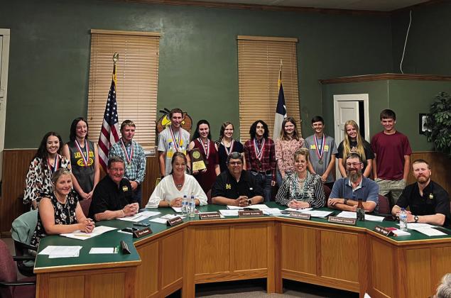 School board members seated l to r: Kyra Ramon, Steve Terrell, Amy Bannowsky, Superintendant of Schools; Arnold Saucedo, Tami Russell, Matt Gainer, and Willy Wright. Students standing l to r: Aminy Anderson, Katherine Russell, Mathis Martin, Wyatt Terrell, Katelyn Maher, Kasey McCullom, James Hernandez, Khloe McCaffery, Roy Brown, Addy Bannowsky, Cado Bannowsky. See results on page 6. The Bannowsky siblings competed in the State CX Debate earlier in the year. Courtesy photo.