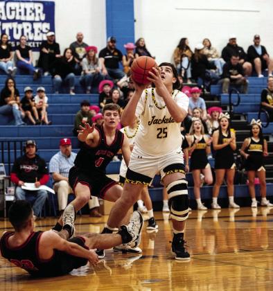 Ayden Ramon #25 bests the defense to shoot for 2 in Monday’s playoff loss against Garden City. Senior Kade Rayburn #4 stiff arms the