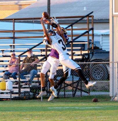 Menard's Jayden Payton snags a pass away from a Mullin Bulldog during their game last Thursday. The Jackets came out on top 52-7. Nora Davis, photo.