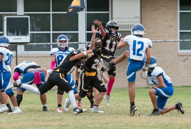 LOTS OF ACTION going on during Menard's 63-12 win over Nueces Canyon last Friday. Pictured blocking a Panther extra point is Hunter Squiers (#0), Benjamin Burch (#26), Maddox Saiz (#11), and Korbin Squiers in the back (#15). Nora Davis, photo.