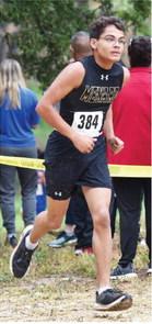 BELOW LEFT- Floyd Teague fights to the finish line at the Mertzon meet.