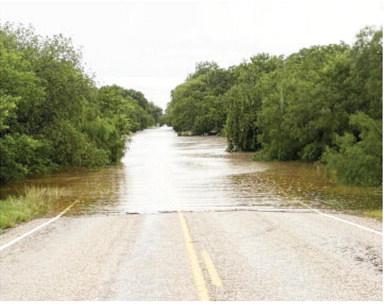 Looking west across the 5-Mile Crossing on FM 2092 E the morning of Friday, July 4. Riley Smith, photo.