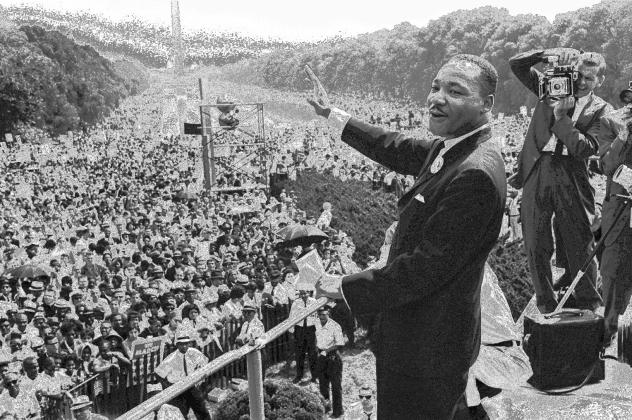 Martin Luther King Jr. waves to supporters from the steps of the Lincoln Memorial, Aug. 28, 1963, during the March on Washington. AP/Getty images.