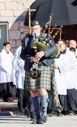 ABOVE- A bagpipe-led processional traveled a block from downtown San Saba Ave. to the historic original Catholic church which was recently renovated.