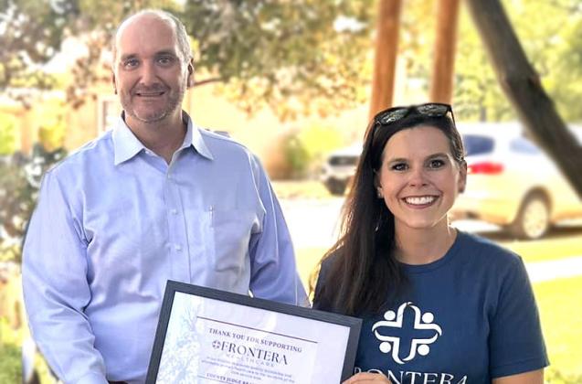 Frontera CEO Mikki Hand (R) presents Menard County Judge Brandon Corbin with an appreciation certificate for supporting Frontera Healthcare.