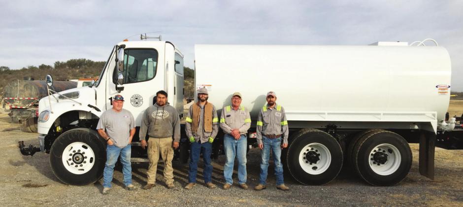 COUNTY WELCOMES NEW EQUIPMENT- County employees stand with the new, functioning water truck the county recently acquired. Pictured are, left to right: Cody Timms, Josh Ortega, Dray Lawler, Bruce Toeppich, and James Davis. Not pictured, as he was taking the photo, is Foreman Harold Gerber. Courtesy photo.