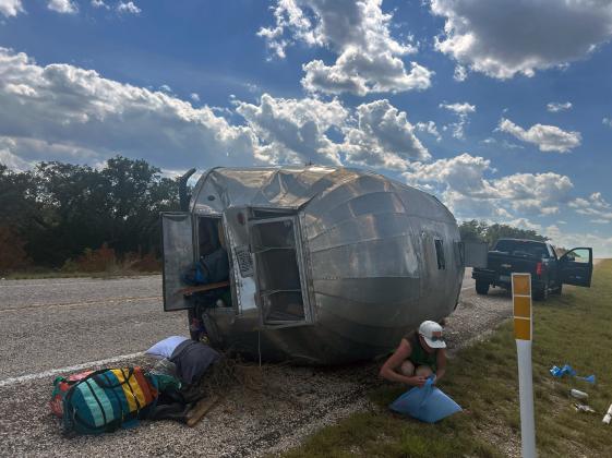 It was a sunny Tuesday afternoon this week when a pickup pulling a camping trailer unhitched from the vehicle and flipped onto its side. Preliminary consideration suggests the rig was traveling too fast downhill on SH 29 about 6 miles east of Menard. The vehicle and its two occupants were unharmed. Traffic was briefly interrupted only when the tow truck loaded the trailer. MCSO photo.