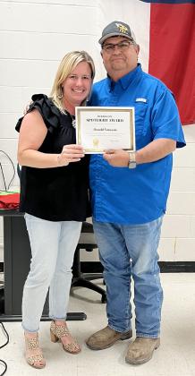 PTO President Valera Corbin presents Arnold Saucedo with the organization's Spotlight Award for his years of dedication to the youth of Menard. This recognition was previously known as the Lifetime Award. TMN photo.