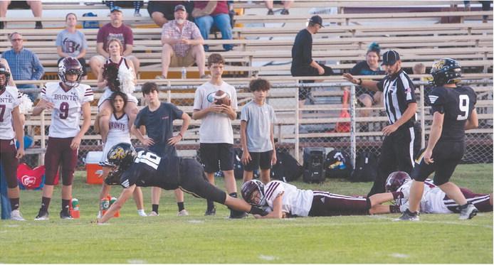 ONE. MORE. YARD. Is what senior John Michael Eggleston (16) was reaching for last Friday during the Yellowjackets' homecoming win against Bronte. Senior Hunter Whitaker (9) checks in at the end of the trail of Longhorns left in Eggleston's wake. Nora Davis, photo.