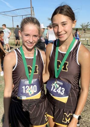 STARTING THE SEASON ON TOP- Freshman Taytum Chambless, left, and sophomore Danni Ruiz both medaled at the first cross country meet in Eldorado last week. Danni, who placed eighth in last year's state meet, won the Eldorado contest. Chambless battled until the end to claim third. Saller photo.