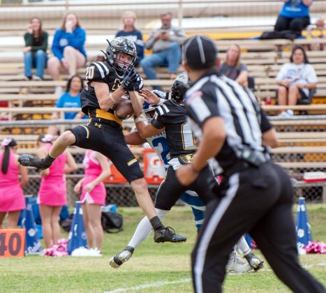 BRYCE DAVIS rustles up some trouble for a Nueces Canyon player last Friday at home.