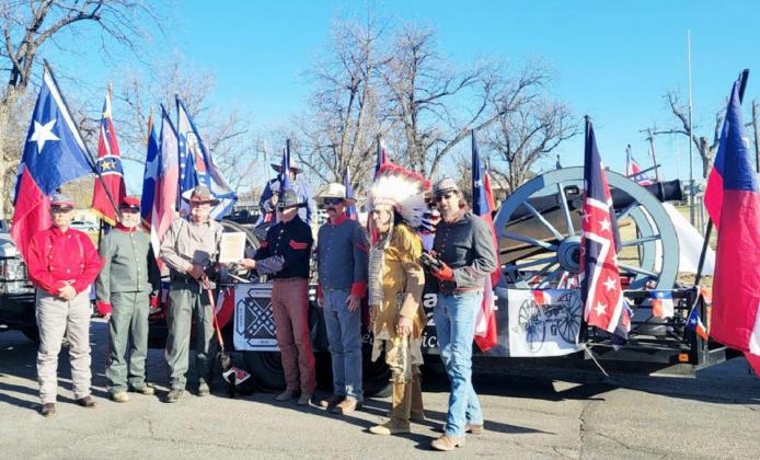 PARADE MARCHERS- Menard’s Fort McKavett Sons of Confederate Veterans Camp 2326 are pictured, from left to right: Eddie Bostwick, Gary Bates, Barry Kniffen, John Kniffen, Buck Bostwick, Dutch Fowler, Ray Hernandez, Wayne Carlile. The group was awarded the winner of the non-commercial float category. Courtesy photo.