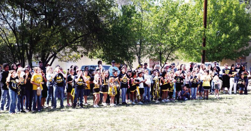 ABOVE- Young students line the perimeter of the action, cheering loud for the Jackets at the annual community-wide pep rally at American Legion Park.