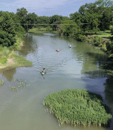San Saba River kayakers paddle east near the high bridge last spring. TMN file photo.