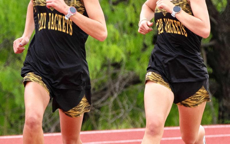 Junior Danni Ruiz and sophomore Taytum Chambless both qualified for the state track meet next weekend in Austin. Danni won the 400m, 800m and 1600m. Taytum was second in the 3200m. The girls are pictured here outrunning the competition together at the district meet in April. Photo by Nora Davis.