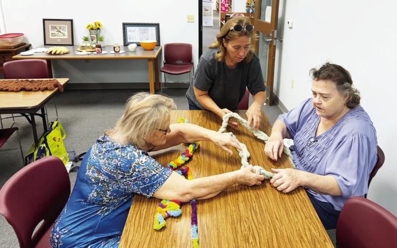 MENARD KNITTY GRITTIES CRAFT GROUP- Kathy Ryan, Christi Sanders and Dianne Simmons learn to finger knit with chunky yarn at the library's first arts and crafts gathering. The class meets on Thursday mornings, aside from the fourth Thursday of each month. For more information contact the library at 325-396-2717. Courtesy photo.
