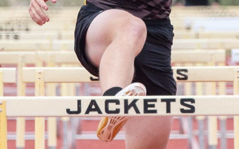 ABOVE- Benjamin Burch approaches the finish line during his second place finish in the boys 110m hurdles at the district meet last week. RIGHT- Makenzie Wright on her way to the girls 100m hurdles victory at the district meet. Wright swept the girls hurdles, winning the gold in 300m hurdles as well.