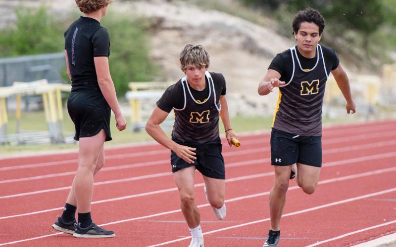 RIGHT- Marlee Salas hands off to Bryce Davis for the final leg of the boys 4x200m relay. The Jacket team of Compton, Saiz, Salas and Davis placed first.