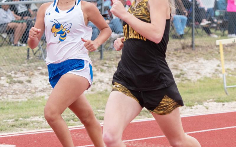 BELOW- Aubree Hernandez hands off to Perla Pecina in the girls 4x100m sprint relay at the district meet. The team of Whitaker, Ruiz, Hernandez and Pecina claimed a silver medal.