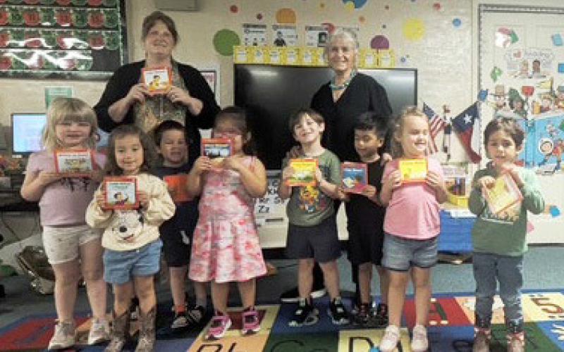 The Menard-Kimble-Mason chapter of the Texas Retired Teachers Association (TRTA) recently presented each Menard Elementary Pre-K students with their own book to take home for the summer. Each gift includes a note of instruction walking an adult through how to help them progress through the book and keep their skills sharp for Kindergarten in the fall. Pictured with the Pre-K class is teacher Amy Allison and Marcy Holmes-Wheeler with TRTA. Courtesy photo.