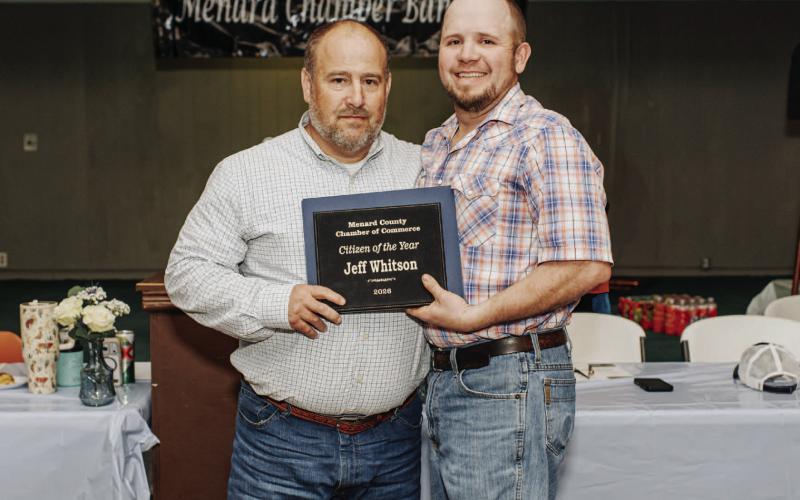 CONGRATULATIONS to Menard Emergency Management Coordinator (EMC) Je Whitson, left, on receiving the distinguished Citizen of the Year Award at the Chamber of Commerce's annual banquet last week. Chamber board member Tyler Wagner, right, presents the plaque. See page 8 for additional awards. Raque Guerrero, photo.