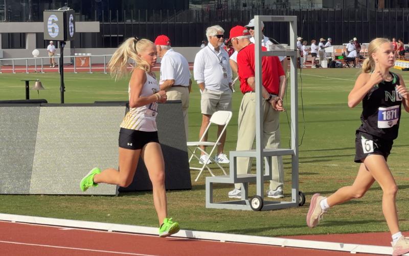 SOPHOMORE LADY JACKET Taytum Chambless, left, makes an effort to stay with the pack during the 3200m run at her first trip to the state meet on Saturday. TMN photo.