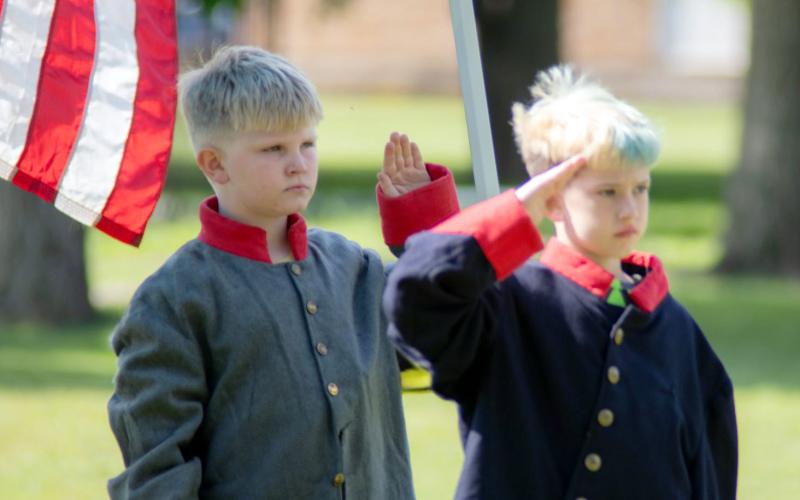Youngsters Zach Childs and Jackson Smith pay their respects during the annual Memorial Day observance at American Legion Park.