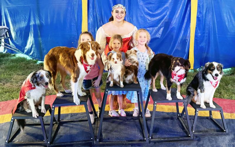 YOUNG CIRCUS-GOERS Byler Barrett (she’s back there!), Reece Johns and Selah Roberson were able to meet Miss Gianna and her performing dogs after a performance of the Culpepper &amp;amp; Merriweather circus on Sunday in Menard. Courtesy photo.