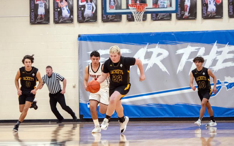 LAST SWARM DOWN THE COURT for senior Tate Wagner, center. Marlee Salas and Julius Zamora follow Wagner back to offense during the Jackets' 31-60 bi-district loss to Garden City on Tuesday. Menard boys will lose 3 players to graduation this year: Tate Wagner, Jaegar Leonard and Bryce Davis. Nora Davis photo.