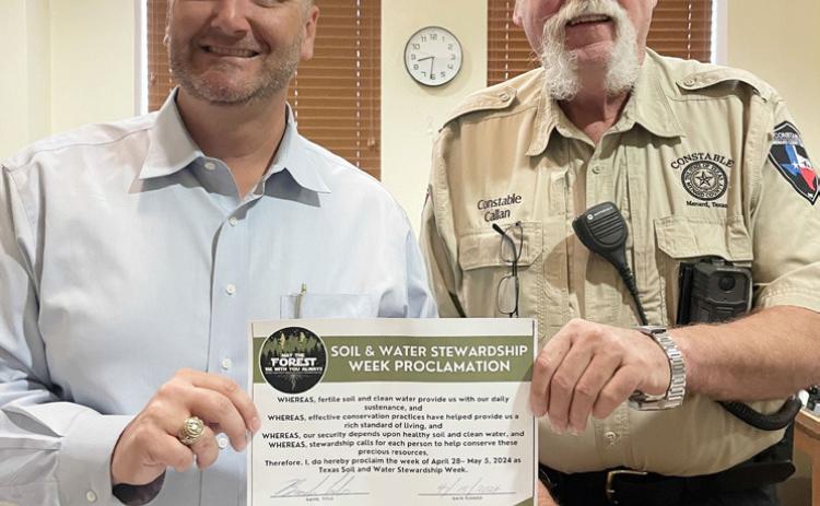 ABOVE- Menard County Judge Brandon Corbin is pictured after signing the Stewardship Week proclamation. Constable Lee Callan joined in.