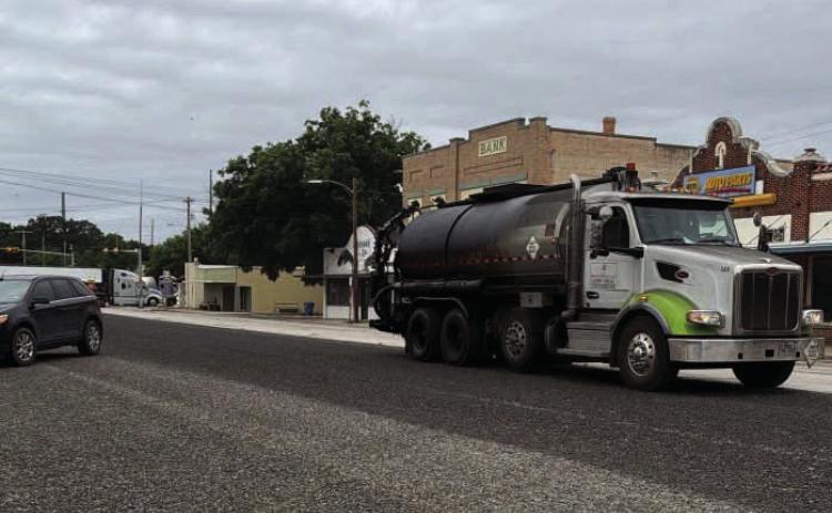TxDOT contractors began chip seal (tar and gravel) coating Farm to Market Road FM 2092 late last week, reaching the town portion known as San Saba Avenue on Monday. The town portion was completed just in time for the rain. Chamber of Commerce photo.