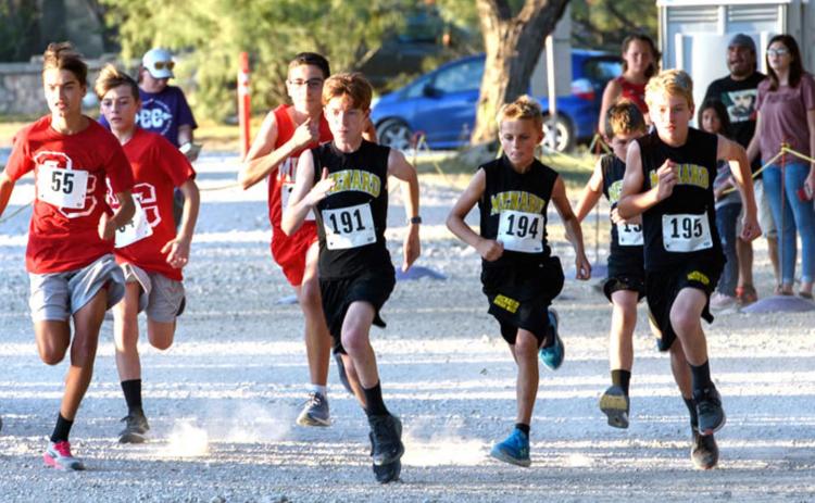 ON YOUR MARKS. GET SET. GO! Junior Jacket cross country runners, to the right in dark jerseys, launch off the starting line of the Irion County meet. Menard runners pictured are, L-R- Bryce Davis (#191), Jaeger Leonard, Brayden Ramon, Tucker Pullen, Tate Wagner, Cado Bannowsky. Photo by Nora Davis.