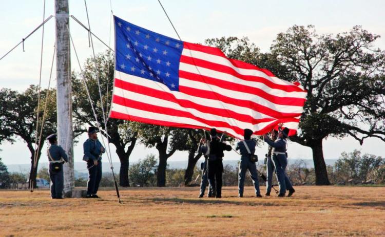 Ft. McKavett’s special event this weekend will include a flag raising similar to the one pictured above. Ft.McKavett State Historical Site photo.