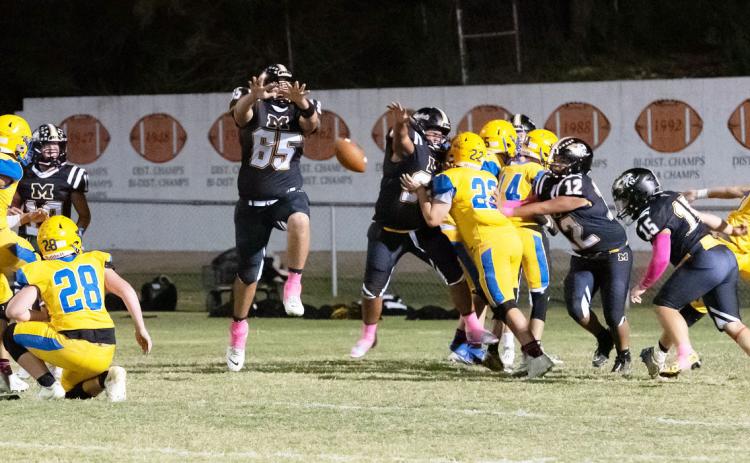 HERE, KITTY KITTY- Yellowjacket Aidan Ramon (#65) gets in the middle of a Medina Bobcat PAT during the Jackets' 80-57 district win at home last week. Hunter Squiers, Zeke Hernandez, Dario Gonzales, and Korbin Squiers are pictured left to right. Nora Davis, photo.