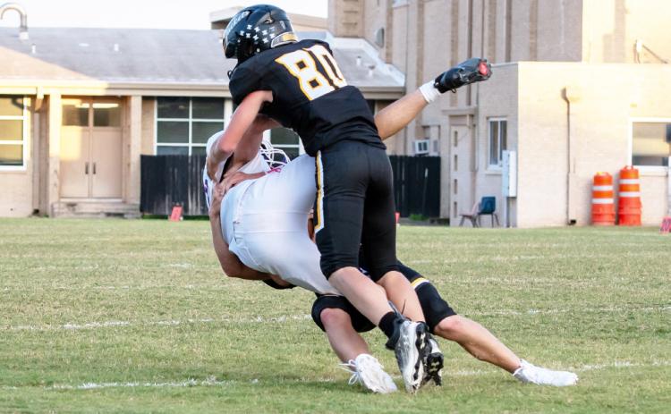 ZONK! Sophomore Cade Bannowsky (80) teams up with sophomore Benjamin Burch (legs) for a take down against Irion County JV last week.