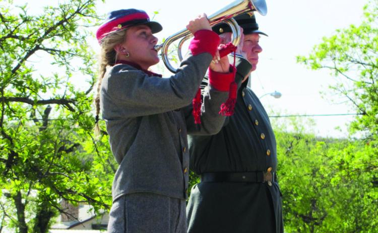 ABOVE- Taylor McCrory plays Tapps at the recent Decoration Day veteran rememberance at Menard’s Pioneer Rest Cemetry. Col. Terry Kelley (Ret.) salutes. Volunteers gathered to place flags upon the graves of the veterans at rest in the cemetery. Photo by Carl Laning. View additional event photos by Laning by scanning the QR code.