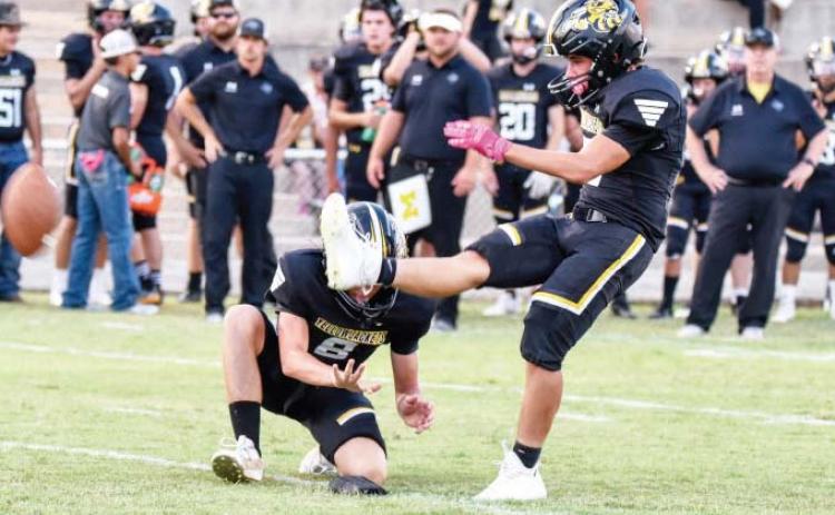 Senior Kade Rayburn kicks off for the inaugural game of the season. Madolyn Nasworthy photo.