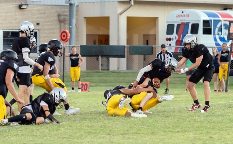 ABOVE- A couple of Yellowjackets team up to take down a Gorman HS ball carrier during the teams' scrimmage last week. The Jackets have their first game of the season this Friday in Blanket.