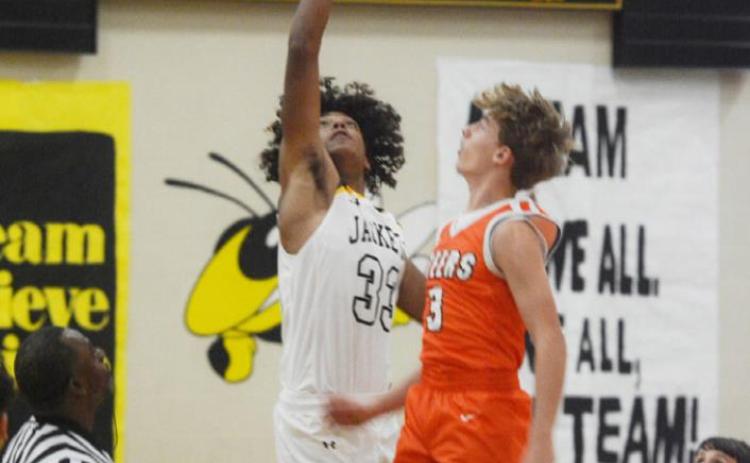 Yellowjacket Isaiah Stanislawski, #33, out-jumps a visiting Steer during the opening tipoff against Robert Lee on November 16 in Menard.