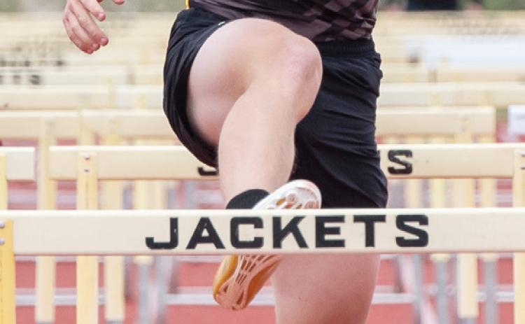 ABOVE- Benjamin Burch approaches the finish line during his second place finish in the boys 110m hurdles at the district meet last week. RIGHT- Makenzie Wright on her way to the girls 100m hurdles victory at the district meet. Wright swept the girls hurdles, winning the gold in 300m hurdles as well.