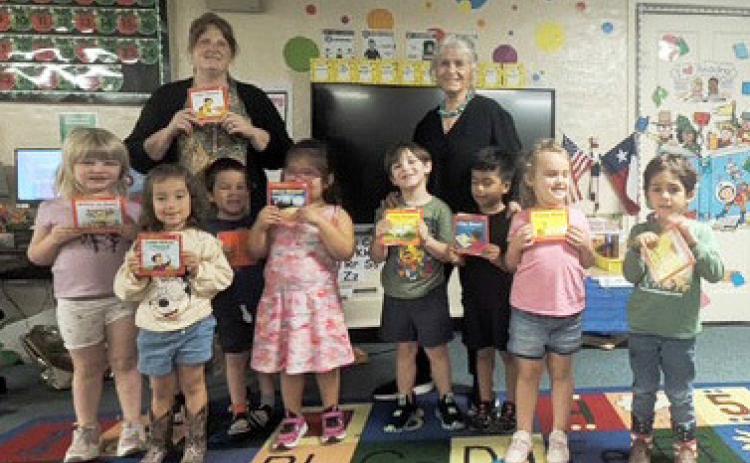 The Menard-Kimble-Mason chapter of the Texas Retired Teachers Association (TRTA) recently presented each Menard Elementary Pre-K students with their own book to take home for the summer. Each gift includes a note of instruction walking an adult through how to help them progress through the book and keep their skills sharp for Kindergarten in the fall. Pictured with the Pre-K class is teacher Amy Allison and Marcy Holmes-Wheeler with TRTA. Courtesy photo.