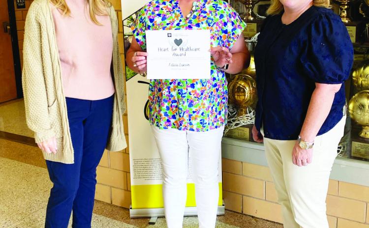 ABOVE- Menard HS counselor Felicia Laxson, center, accepts her Heart for Healthcare recognition from the Texas A&amp;M College of Medicine Rural Health Program. Laxson has been instrumental in inspiring local students to join the field of healthcare. Courtesy photo.