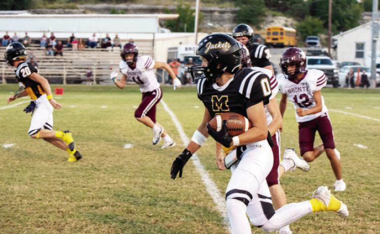 Senior Bryce Davis, far left, clears the way for ball carrier Hunter Squiers on Friday’s win over Bronte.