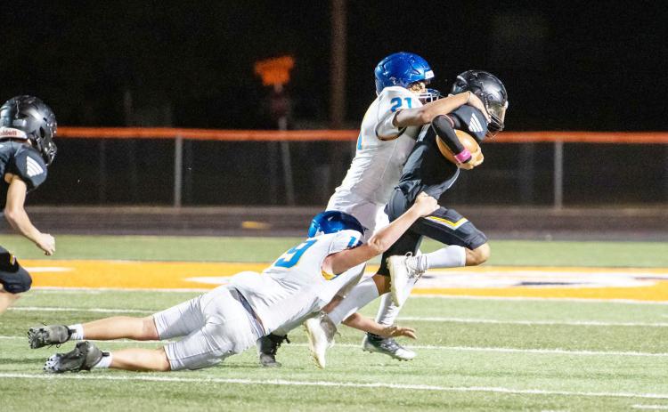 LEFT- JV Maddox Saiz drags a couple of Veribest defenders along for the ride in Menard's win last week. Nora Davis, photo.